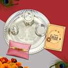 Beautiful Rakhi gift set including silver thali, roli-chawal bowls, greeting card, and Rakhi to honor the sibling bond.