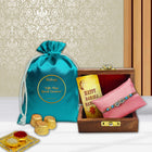 Rakhi set curated with emotional touch — wooden Rakhi box, chocolate pouch, roli-chawal bowls, and message card.